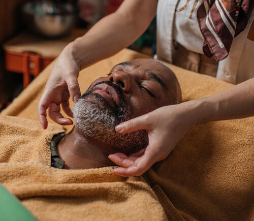 Man receiving a facial massage