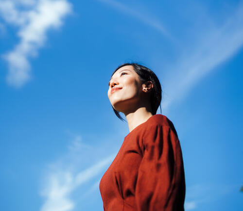 Woman standing in the sunshine