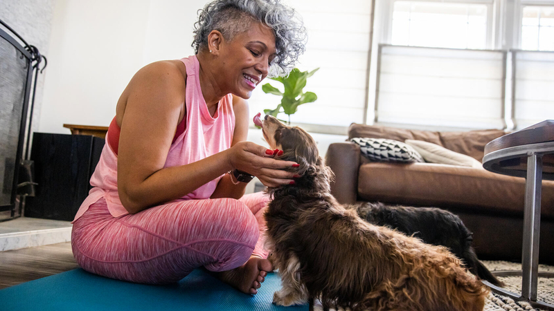 Woman playing with her dog on the floor