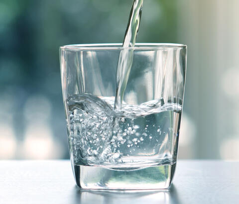 Glass of water being poured