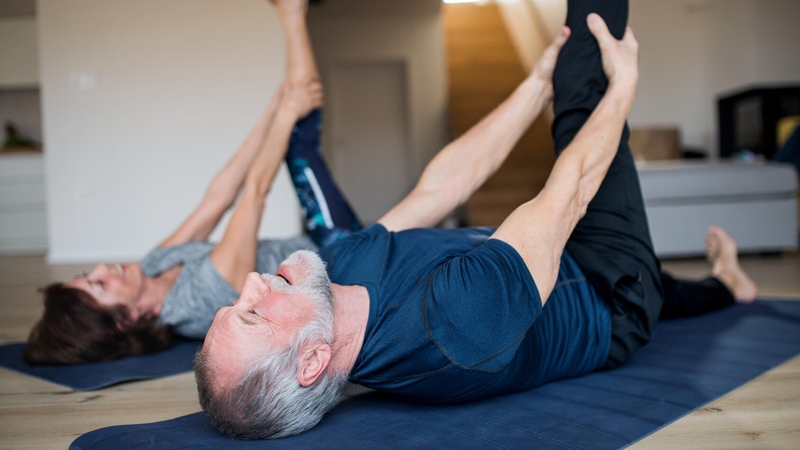 Couple stretching at home