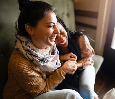 Two friends laughing together