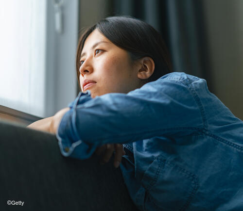 Adult woman looking out a window