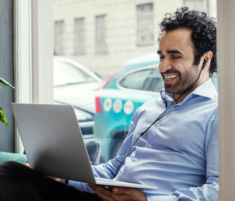 Man with headphones working on laptop