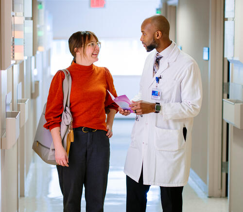 Doctor talking with patient in hallway