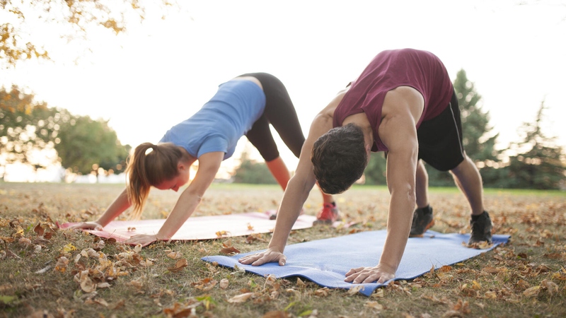 People doing yoga in a park