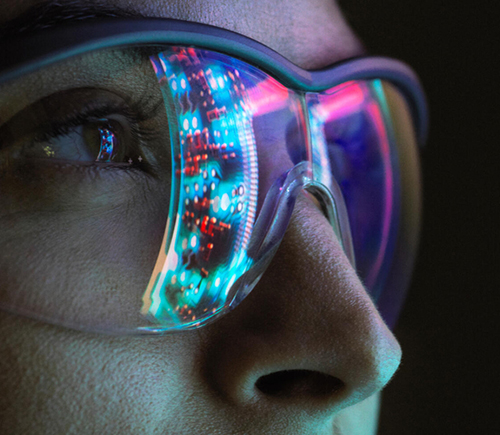 Closeup of screens being reflected off safety glasses