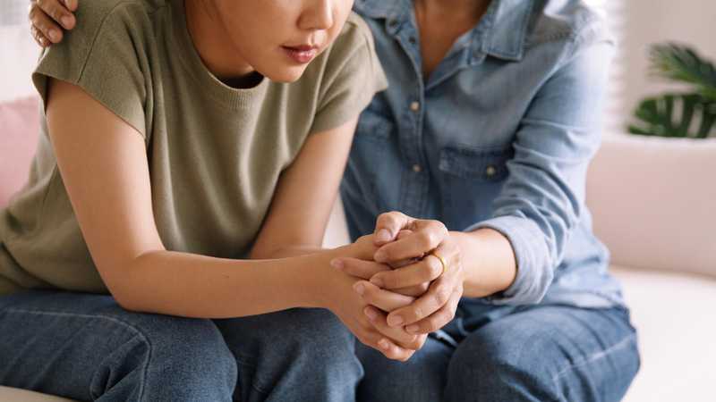 Woman and girl sitting together