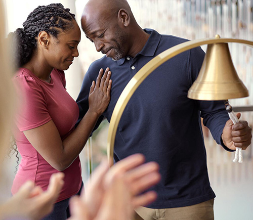 Couple embracing after man rings bell