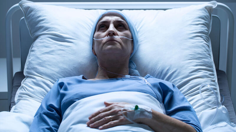 Cancer patient lying in hospital bed