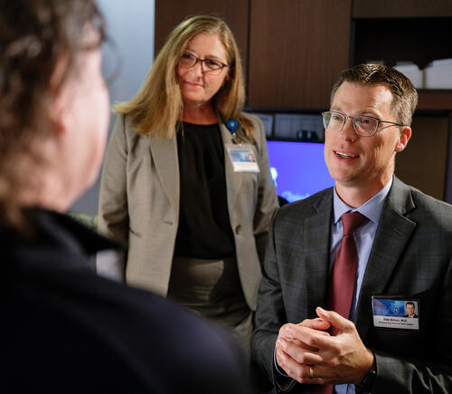 Two doctors talking to a patient