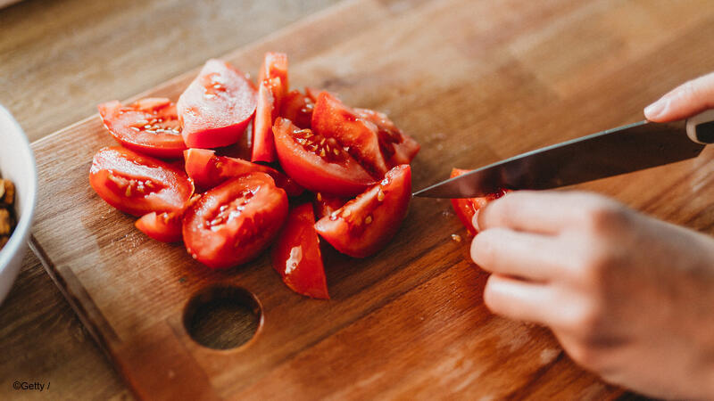 Closeup of tomatoes being cut