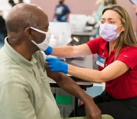 Masked man getting a shot