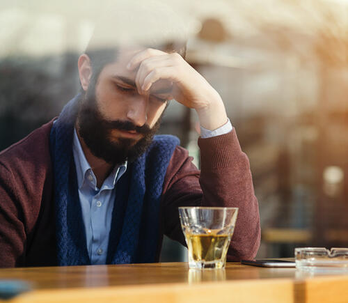 Man sadly sitting at bar