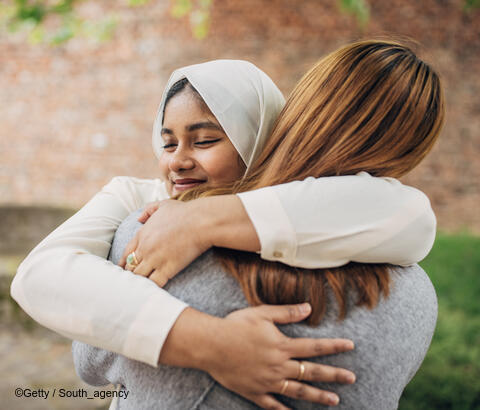 Two friends hugging