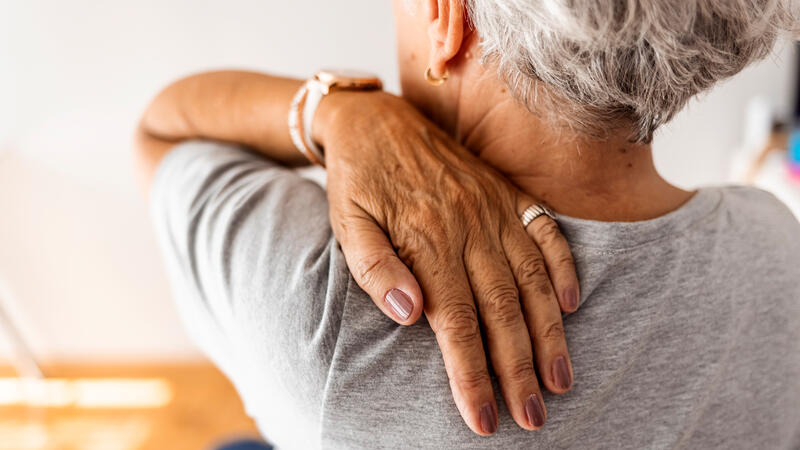 Woman massaging her shoulder