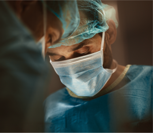 Surgeons wearing masks and looking down