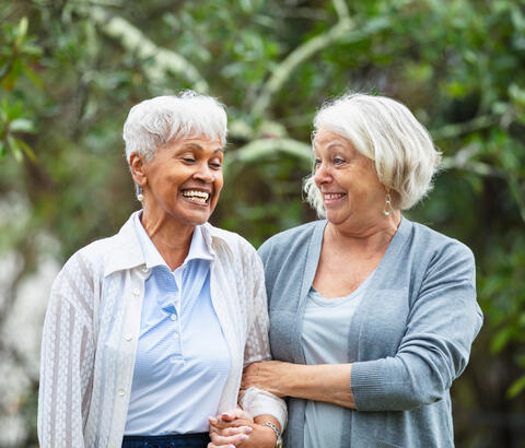 Two older women walking outside