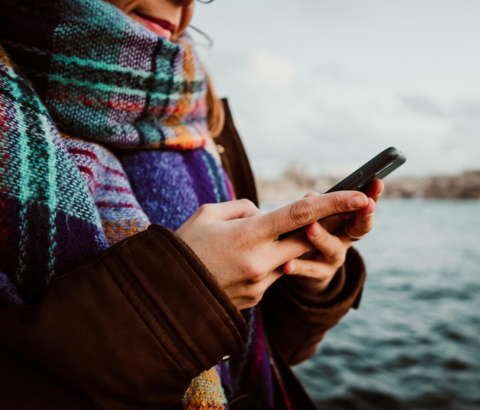 Woman in scarf look at phone