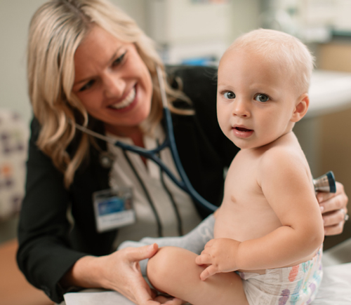 Physician examining a baby