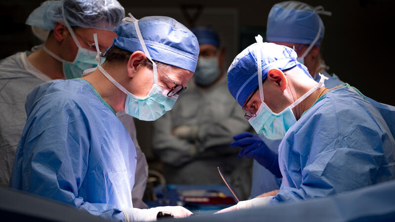 Group of masked doctors in surgery