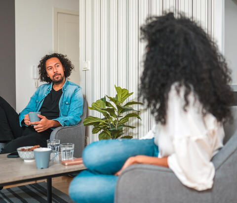 Couple sitting in their living room chatting