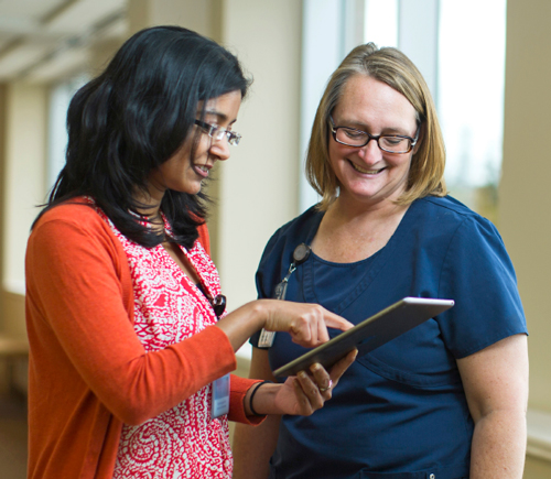 Medical professionals looking at e-tablet