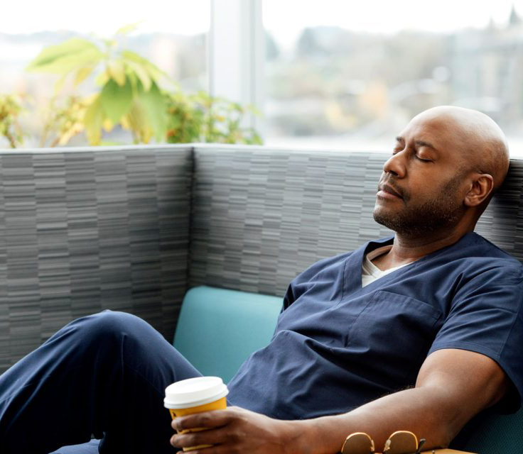 Black man resting with closed eyes.