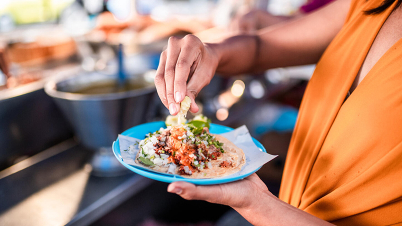 Person squeezing lime on taco