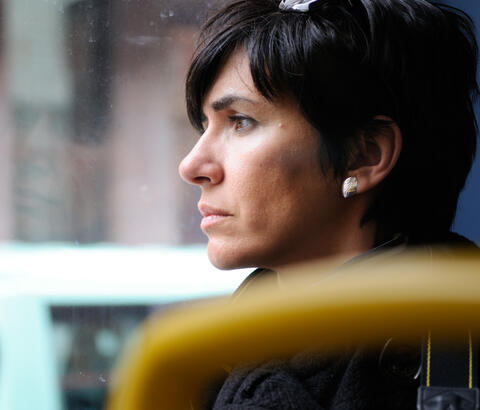 Woman looking out bus window