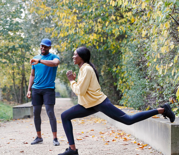 Couple stretching in park