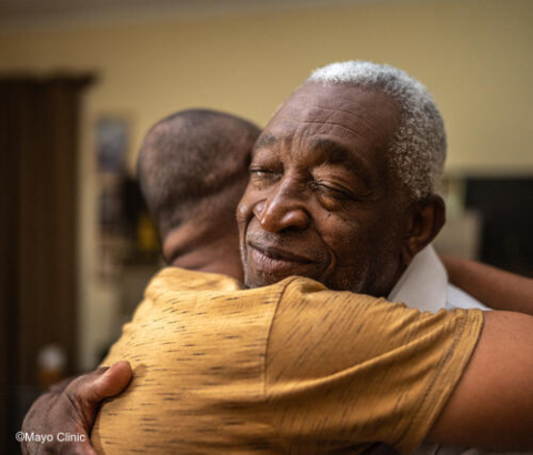 Two men hugging