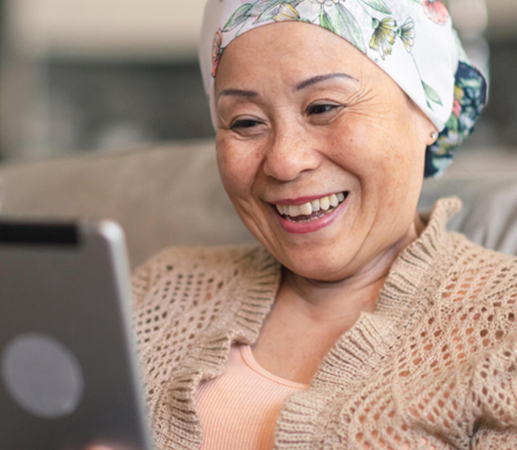 Woman wearing head scarf looks at a tablet