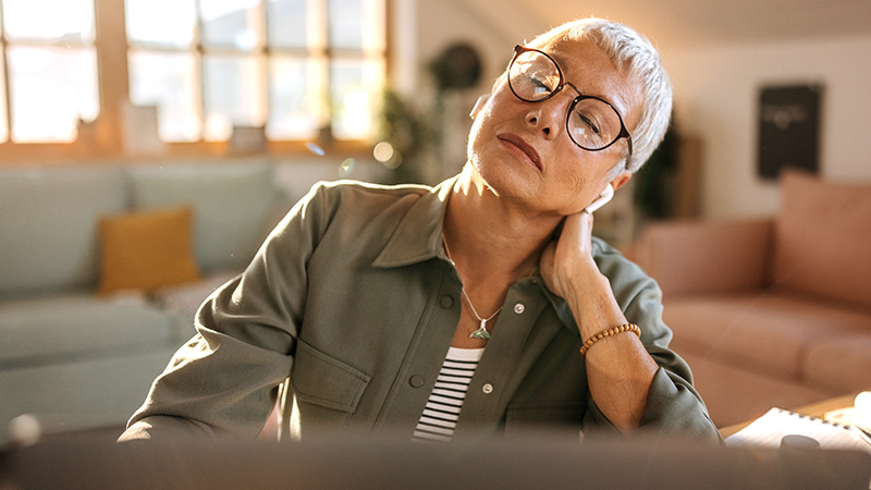 Woman sitting at a computer resting her eyes