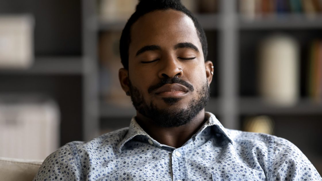 Person sitting with eyes closed