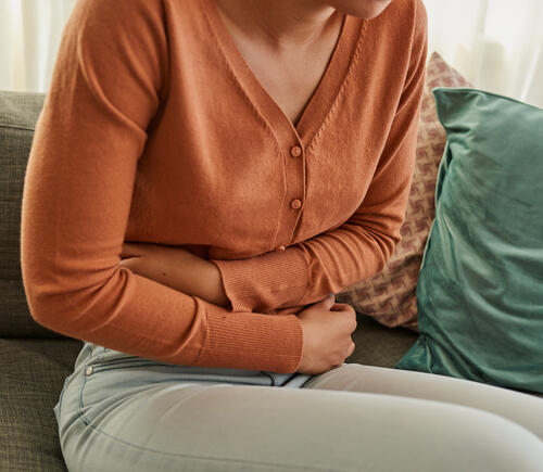 Woman holding her stomach in discomfort