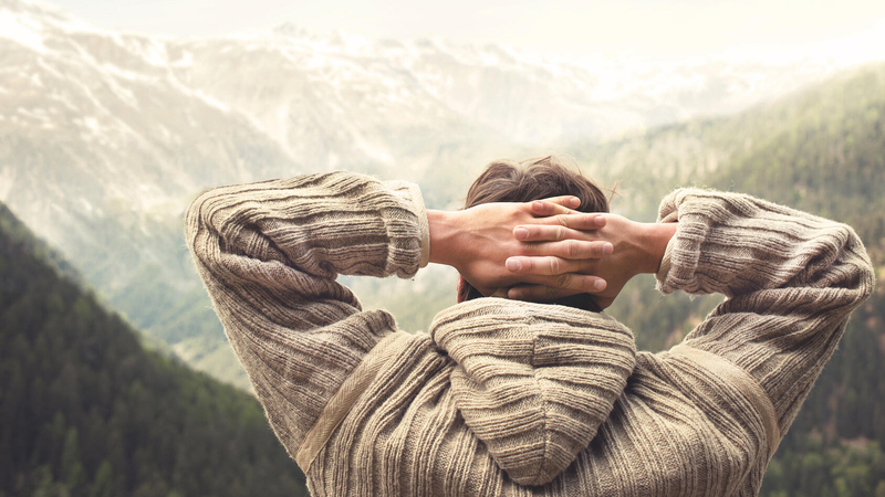 Man in sweater looking at mountain