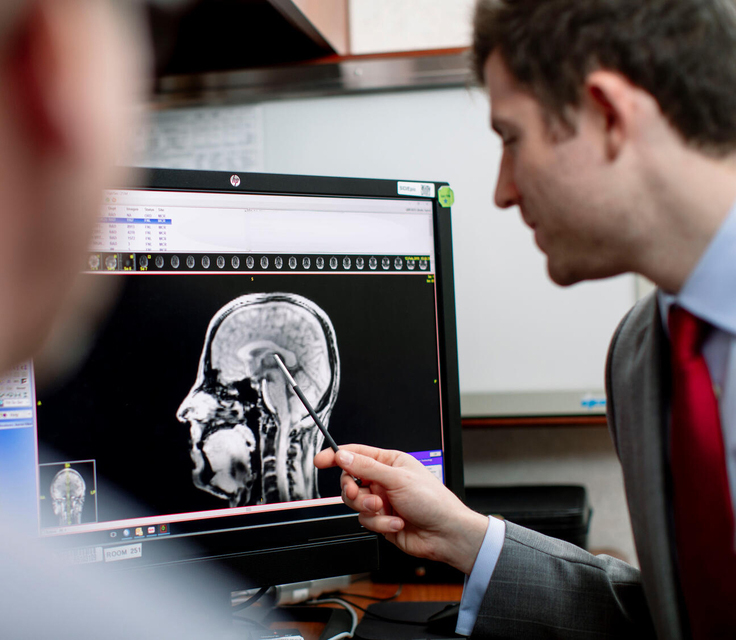 Doctor pointing at brain scan