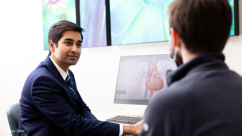 Male physician speaking to patient.