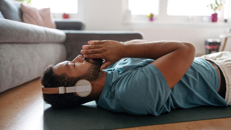 Man meditating with headpones