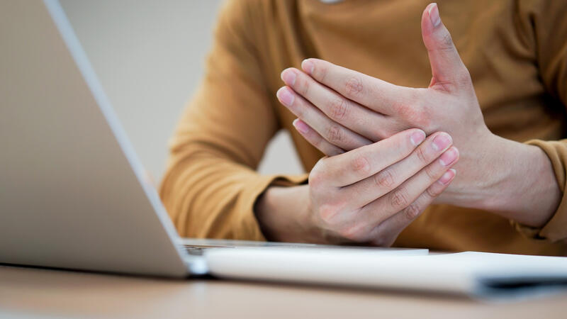 Individual massaging their hand